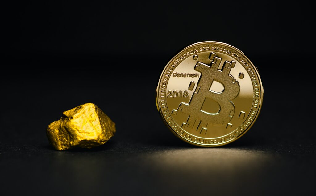 A gold nuggget and a bitcoin coin