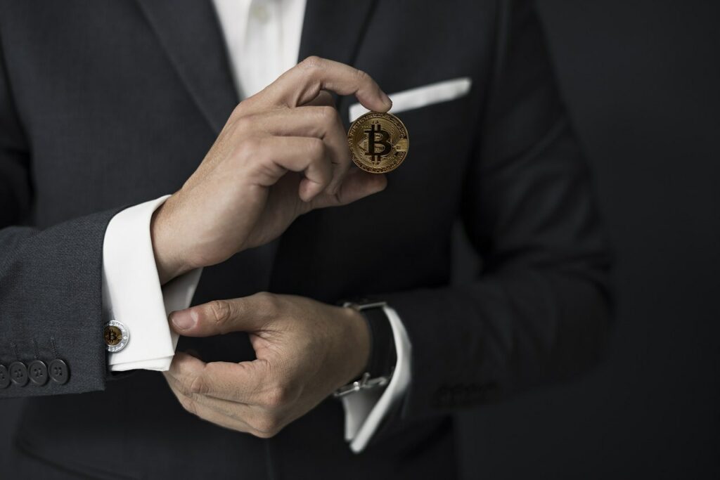 gentleman holding a bitcoin