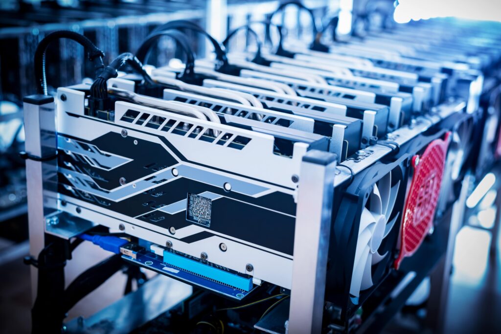 bitcoin mining rigs piled in a frame.