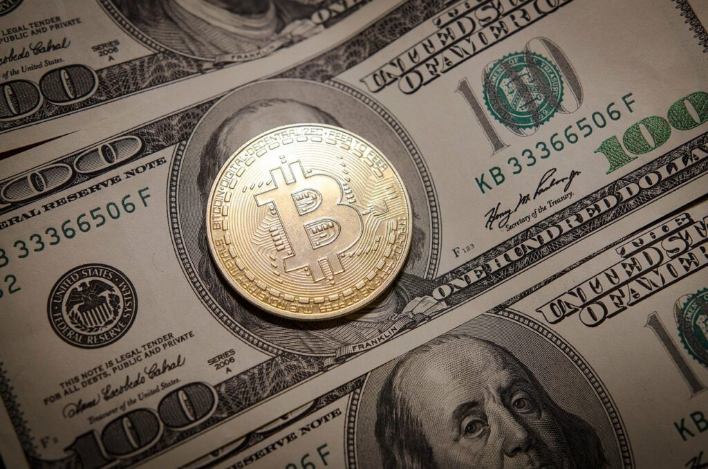 Gold bitcoin on a dollar bill