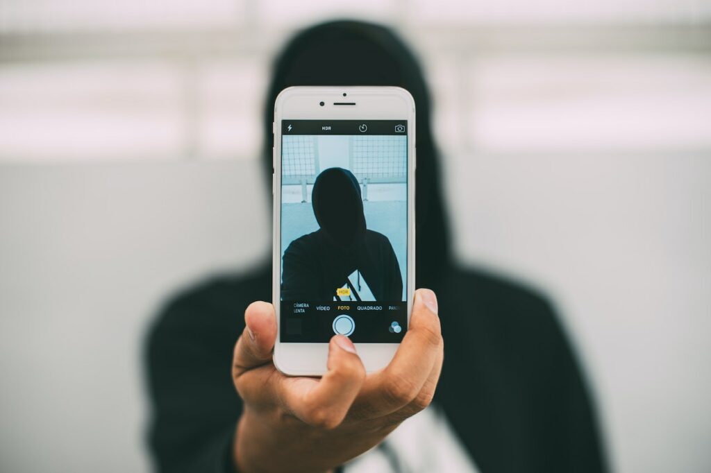 a guy being anonymous with decentralization and having a black hoodie picture on an iphone